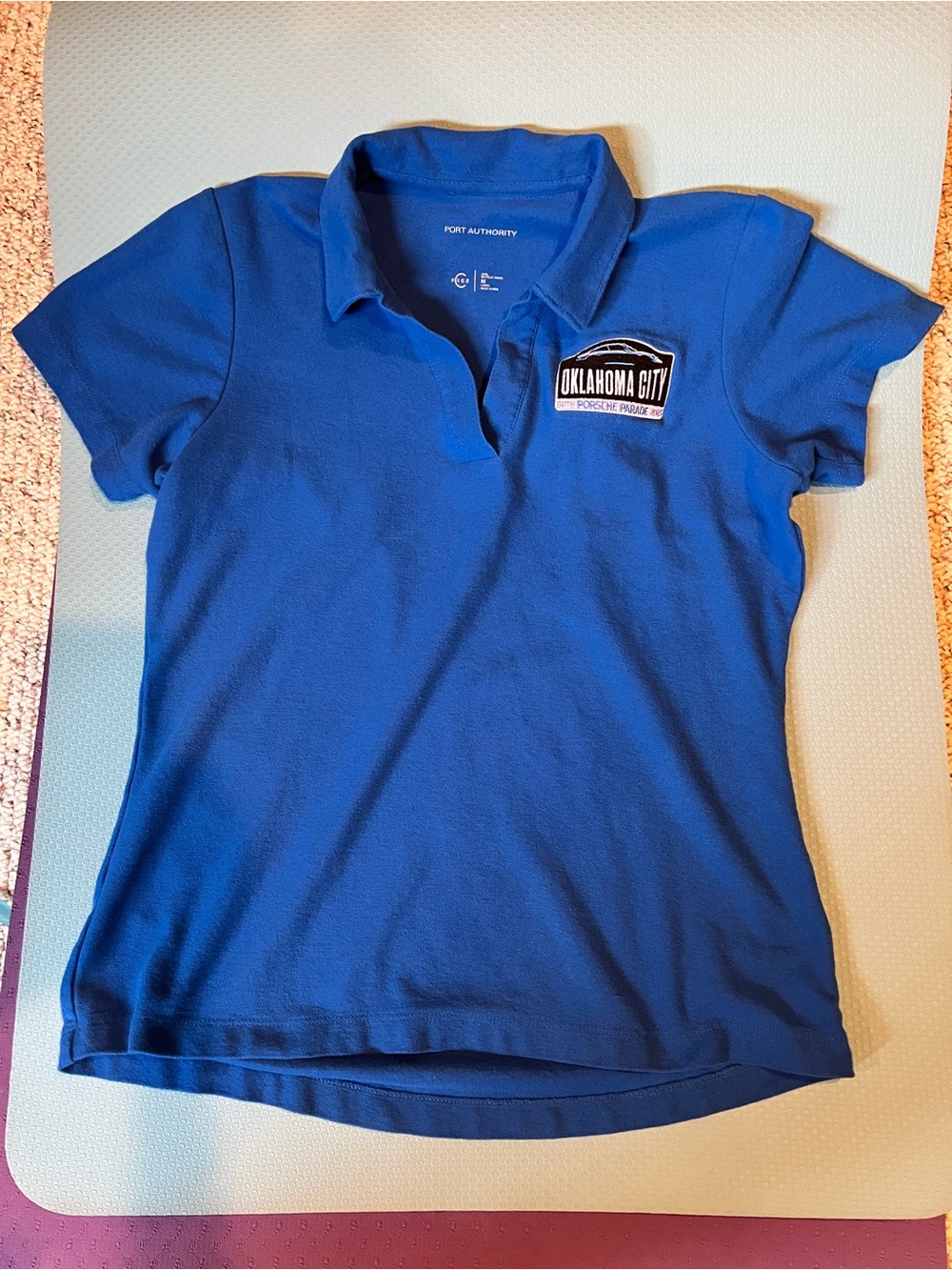 2025 Porsche Parade ladies golf shirt. Oklahoma City embroidered emblem.